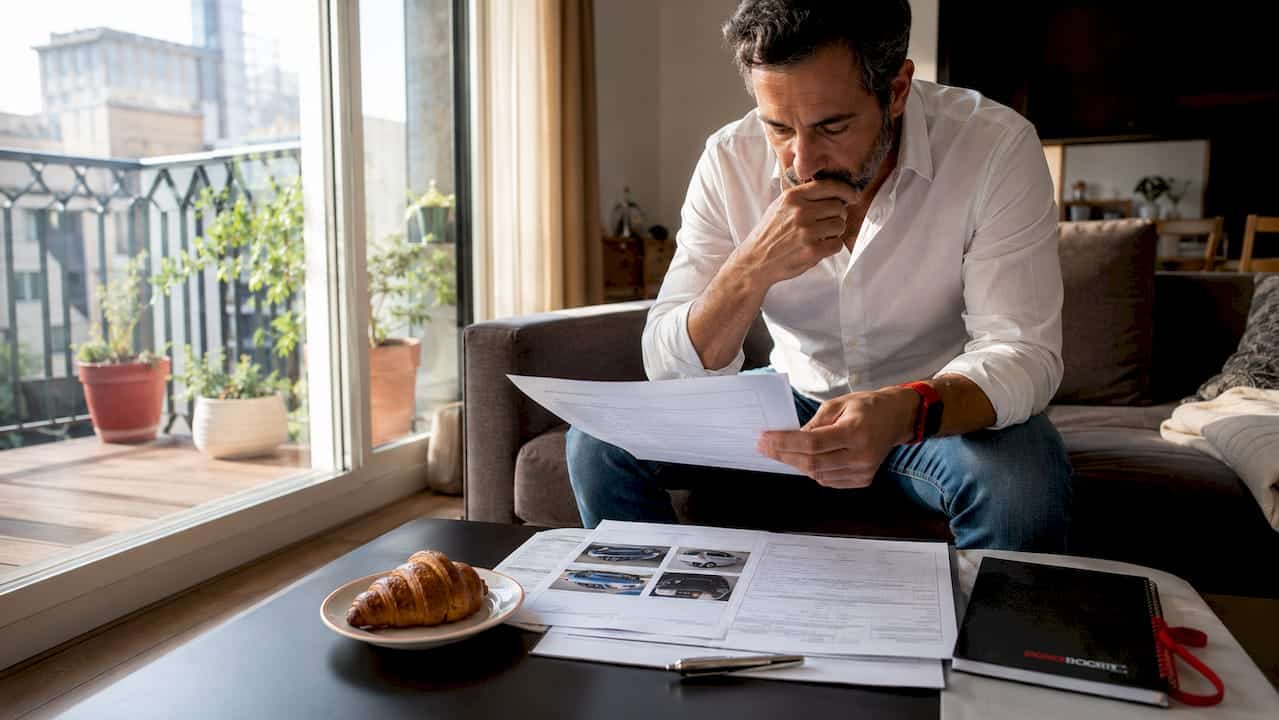 Man reviewing dent repair insurance claim