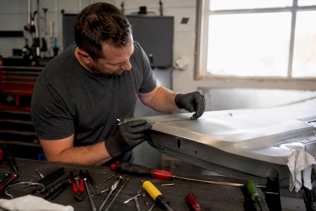 Roof Dent Repair PDR: What Works and When to Walk Away 2 Hands Isolating Steel Pdr Tool From Aluminum Panel