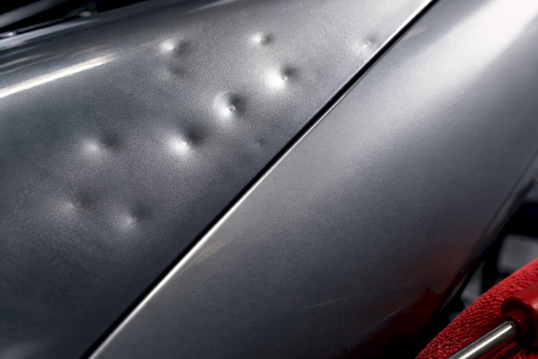 Aluminum panel before-and-after hail repair